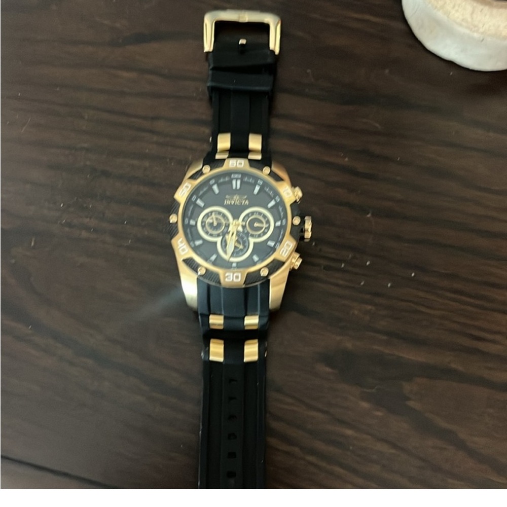 Men’s black and gold Invicta watch